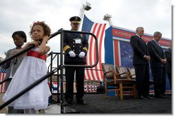 Athen Schwantes, left, joins her daughter as they listen to the invocation during a ceremony at the National Fallen Firefighters Memorial service in Emmitsburg, Md., Sunday, Oct. 7. 2007. White House photo by Chris Greenberg