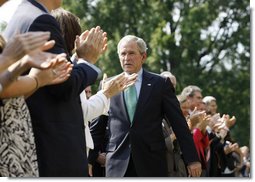 President George W. Bush is applauded following his remarks highlighting the achievements of volunteerism and work of the USA Freedom Corps Monday, Sept. 8, 2008, on the South Lawn of the White House. White House photo by Eric Draper