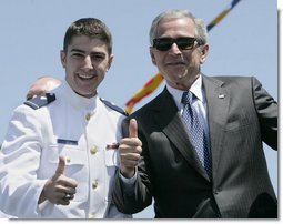 President George W. Bush, wearing the sunglasses of U.S. Coast Guard graduate Steven Matthew Volk, poses with Volk for a thumbs-up photo following the President’s address to the graduates Wednesday, May 23, 2007, at the U.S. Coast Guard Academy commencement in New London, Conn. White House photo by Joyce Boghosian