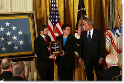 President George W. Bush shares a moment with Tom and Romayne McGinnis, of Knox, Pennsylvania, after presenting them the Congressional Medal of Honor in honor of their son, Private First Class Ross A. McGinnis, who was honored posthumously Monday, June 2, 2008, in the East Room of the White House. White House photo by Joyce N. Boghosian