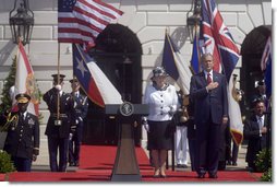 President George W. Bush stands with his hand over his heart during the playing the America’s national anthem during the Arrival Ceremony for Her Majesty Queen Elizabeth II and His Royal Highness The Prince Philip Duke of Edinburgh Monday, May 7, 2007, on the South Lawn. White House photo by Lynden Steele