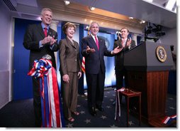 President George W. Bush and Mrs. Laura Bush, with White House Press Secretary Tony Snow, left, welcome reporters and photographers back to the newly re-modeled James S. Brady Press Briefing Room following an official ribbon cutting, Wednesday, July 11, 2007, at the White House. White House Correspondents' Association president Steve Scully is seen at right. White House photo by Eric Draper