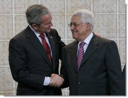 President George W. Bush and President Mahmoud Abbas exchange handshakes Thursday, Jan. 10, 2008, after a joint press availability at Muqata, the headquarters of the Palestinian Authority, in Ramallah. White House photo by Chris Greenberg