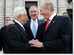 President George W. Bush congratulates President Mahmoud Abbas, left, of the Palestinian Authority, and Prime Minister Ehud Olmert of Israel following their agreement Tuesday, Nov. 27, 2007, to immediately resume long-stalled peace talks. The agreement came during the Annapolis Conference held in Annapolis, Maryland.  White House photo by Chris Greenberg