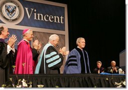 President George W. Bush is applauded by Saint Vincent College President Jim Towey, center, and Washington Archbishop Donald Wuerl as he is introduced on stage Friday, May 11, 2007, prior to delivering the commencement address at Saint Vincent College in Latrobe, Pa. White House photo by Joyce Boghosian