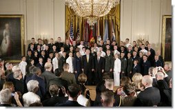 President George W. Bush and U.S. Secretary of Defense Robert Gates pose for a group photo at the commissioning ceremony for Joint Reserve Officer Training Corps Thursday, May 17, 2007, in the East Room of the White House. White House photo by Joyce Boghosian