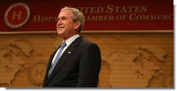 President George W. Bush smiles as he's introduced Wednesday, March 12, 2008, onstage at the Ronald Reagan Building and International Trade Center where he spoke to the United States' Hispanic Chamber of Commerce. The USHCC is the most influential Hispanic business organization in the United States, communicating the needs of Hispanic enterprise to corporate America and the Federal government. White House photo by Joyce N. Boghosian