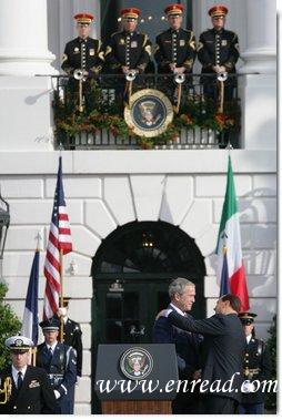 President George W. Bush is embrace by Prime Minister Silvio Berlusconi folllowing President Bush's remarks Monday, Oct. 13, 2008 , welcoming Prime Minister Berlusconi to the White House. White House photo by Chris Greenberg