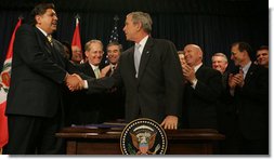 President George W. Bush shakes the hand of Peru's President Alan Garcia after signing H.R. 3688, the United States-Peru Trade Promotion Agreement Implementation Act, Friday, Dec. 14, 2007, in the Dwight D. Eisenhower Executive Office Building. In signing the agreement, the President said, "Peru and the United States are strong partners and today we're making that partnership even stronger."  White House photo by Joyce N. Boghosian