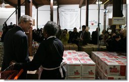 President George W. Bush talks with 85-year-old Doris Lewis Monday, Nov. 19, 2007, during a stop at the Central Virginia Community Food Bank in Richmond, Va. "You have a sweet heart," the President told the volunteer, who was celebrating her birthday at the warehouse. White House photo by Chris Greenberg