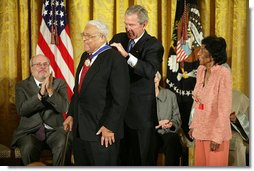 President George W. Bush awards the Presidential Medal of Freedom to civil rights activist Benjamin Hooks as his wife Frances Hooks stands by during a ceremony Monday, Nov. 5, 2007, in the East Room. "The nation best remembers Benjamin Hooks as the leader of the NAACP. For 15 years, Dr. Hooks was a calm yet forceful voice for fairness, opportunity, and personal responsibility. He never tired or faltered in demanding that our nation live up to its founding ideals of liberty and equality," said the President. White House photo by Eric Draper