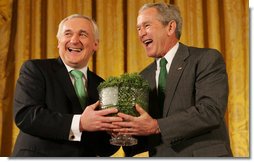 President George W. Bush breaks out in laughter as he's presented a bowl of shamrocks from Prime Minister Bertie Ahern of Ireland during a reception Monday, March 17, 2008, in celebration of St. Patrick's Day. White House photo by Joyce N. Boghosian