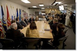 President George W. Bush is joined by Minnesota Governor Tim Pawlenty, U.S. Senator Amy Klobuchar, Minneapolis Mayor R.T. Rybak and other federal, state and local officials, at a briefing Tuesday, Aug. 21, 2007 at the Minneapolis/St. Paul Air Reserve Station, on the recovery efforts at the I-35W bridge collapse site and the flash flooding in southeastern Minnesota. White House photo by Chris Greenberg